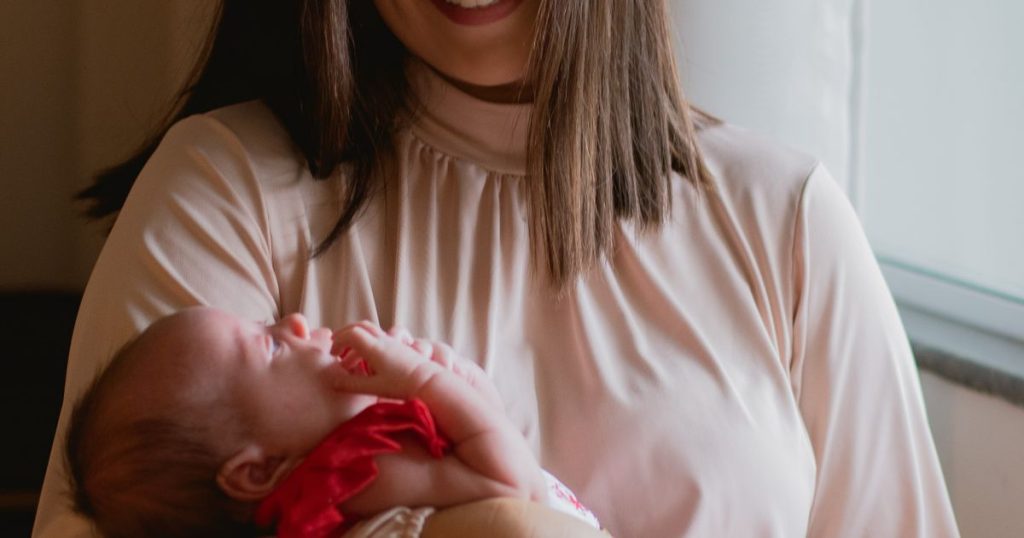 Mother holding a newborn in soft light