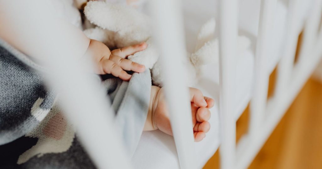 Baby resting in a crib