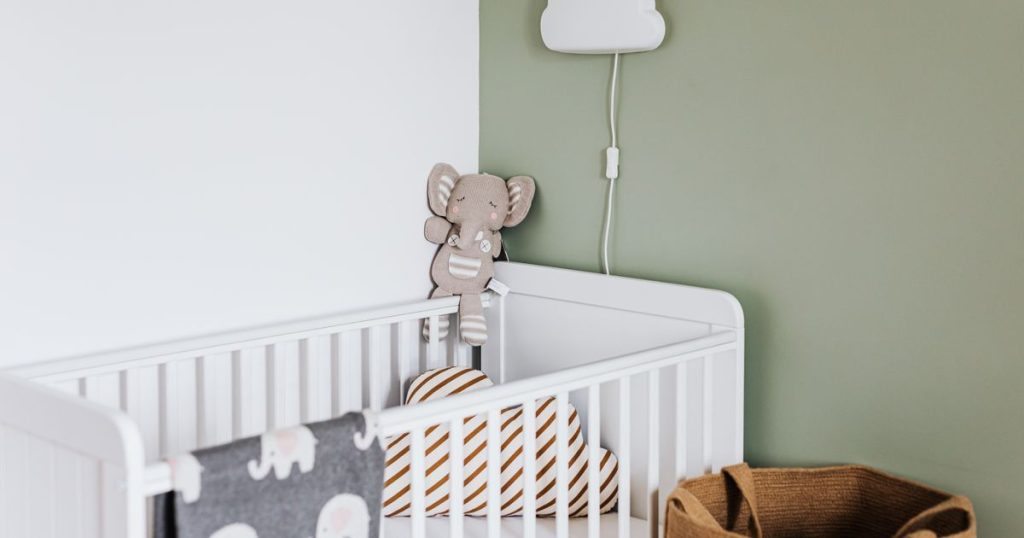 Calm nursery with a crib and mobile