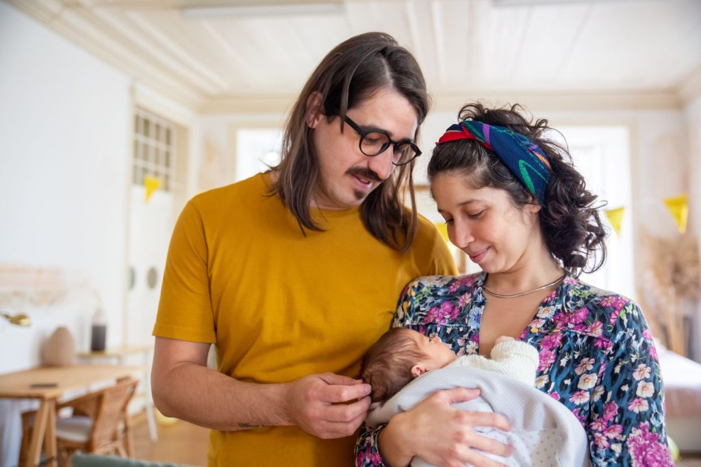 Couple looking down at their newborn