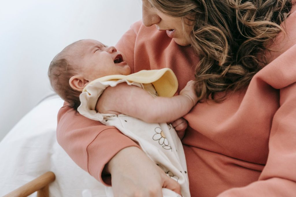 Mother holding her baby against her chest