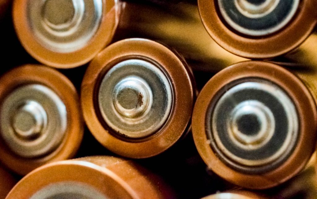 Close-up of the tops of several AA batteries