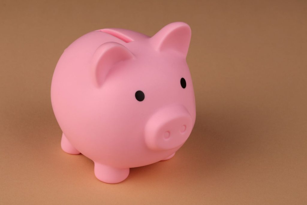 Pink piggy bank on a peach background