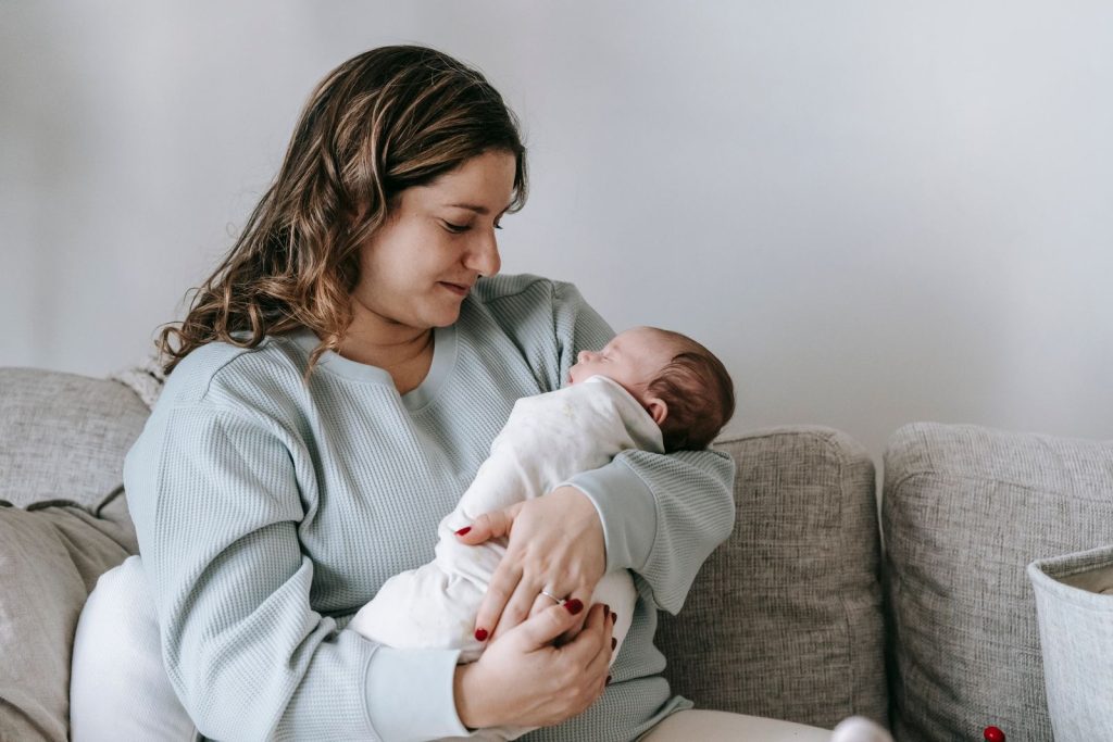 Mother cradling her newborn in her arms