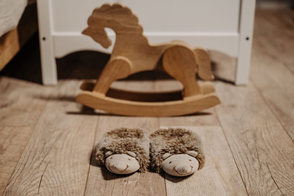 Wooden rocking horse toy on a wooden floor