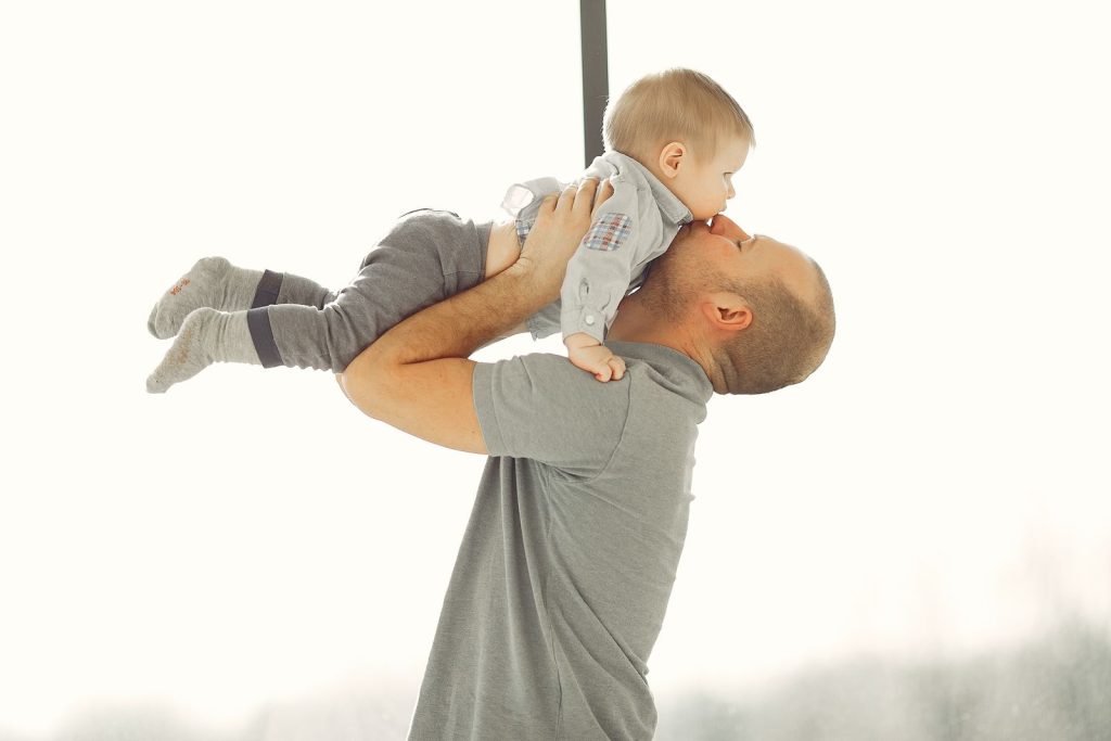 Father lifting his baby into the air