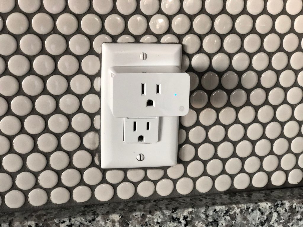 White wall outlet set into a tiled wall