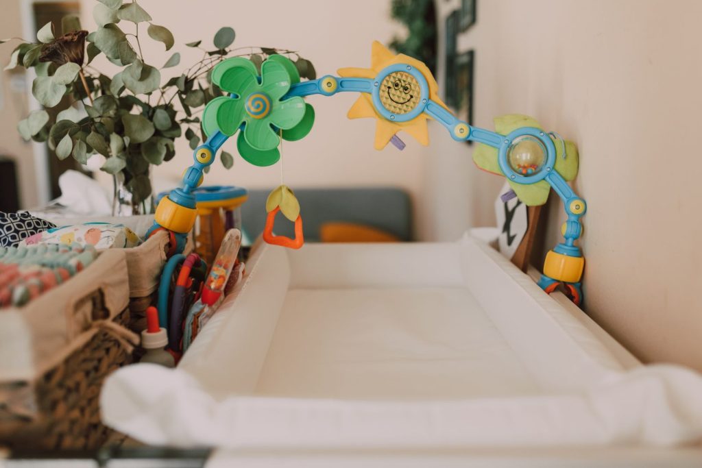 Bassinet insert with a colorful toy arch