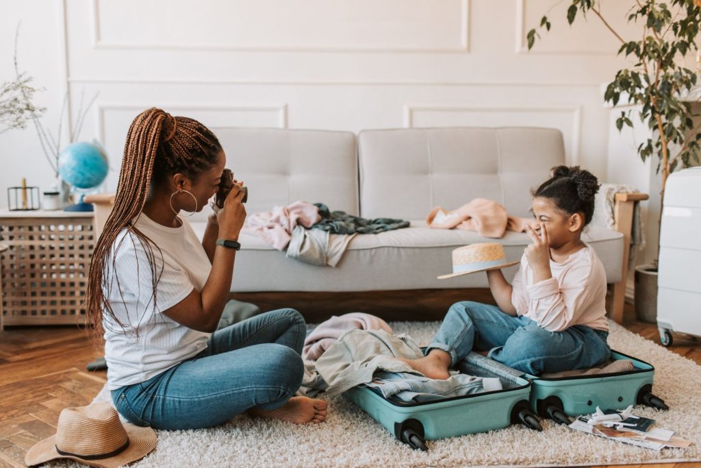 Mother and daughter packing a suitcase together